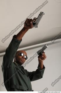 ERIC STANDING POSE WITH GUNS